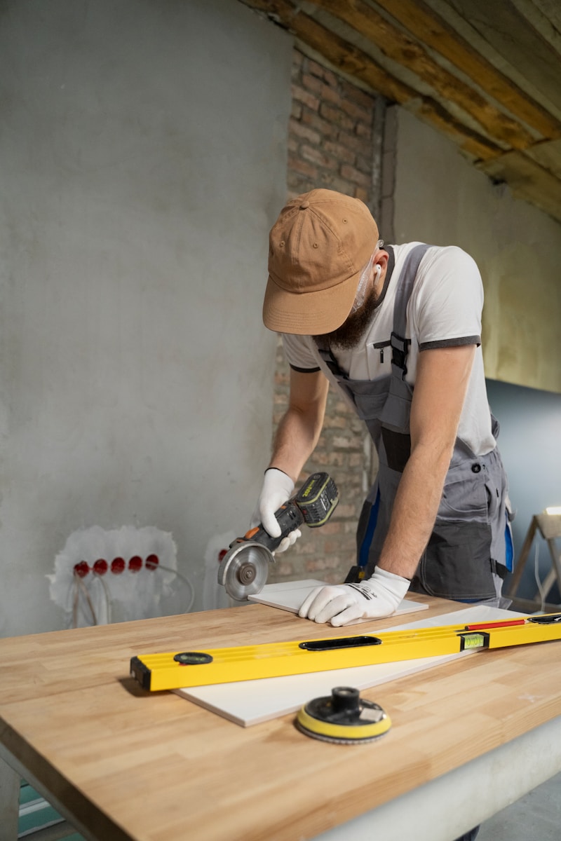 Home Renovations, A man sanding a wooden table with a sander